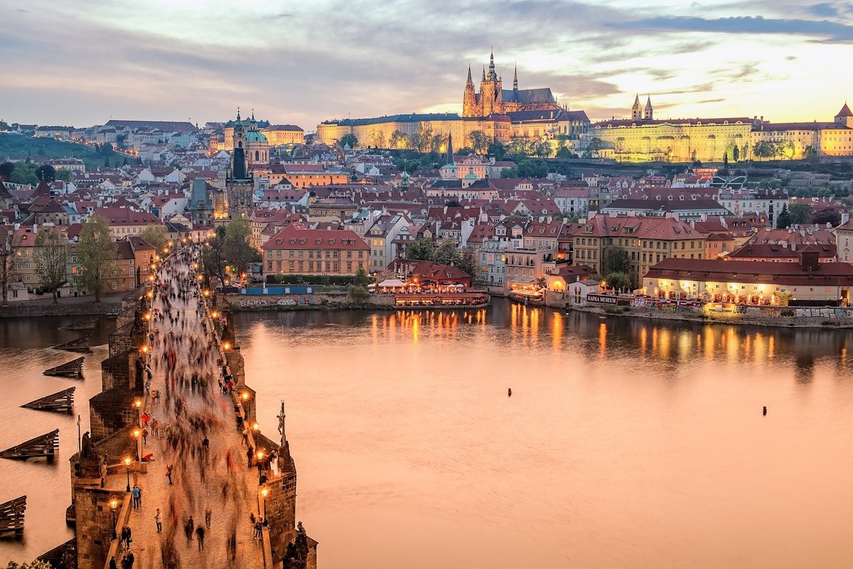 brown concrete building near body of water during daytime in Praga