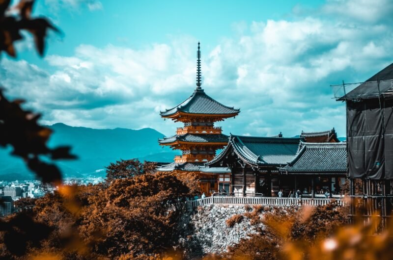 people near pagoda under white and blue sky in Kyoto