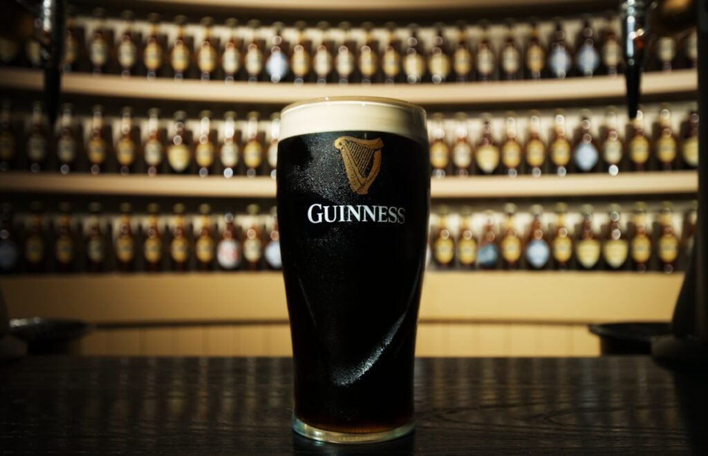a glass of guinness sitting on top of a table in Dublin