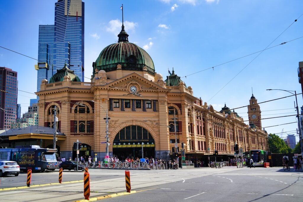a large building with a clock on the top of it Flinders Street Station in Melbourne