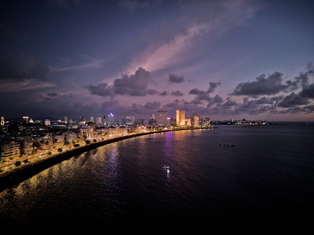 a body of water with a city in the background marine drive mumbai